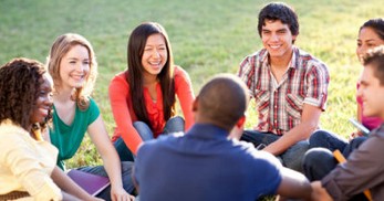 Group Therapy A group of teens sitting on the grass sharing with each other